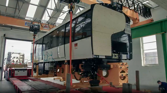 Train carriage being lifted onto the trailer - Alstom